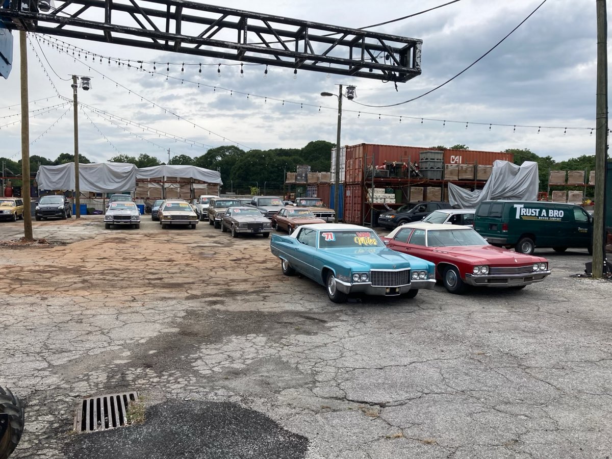 Picture-car lot with classic American cars staged at the front